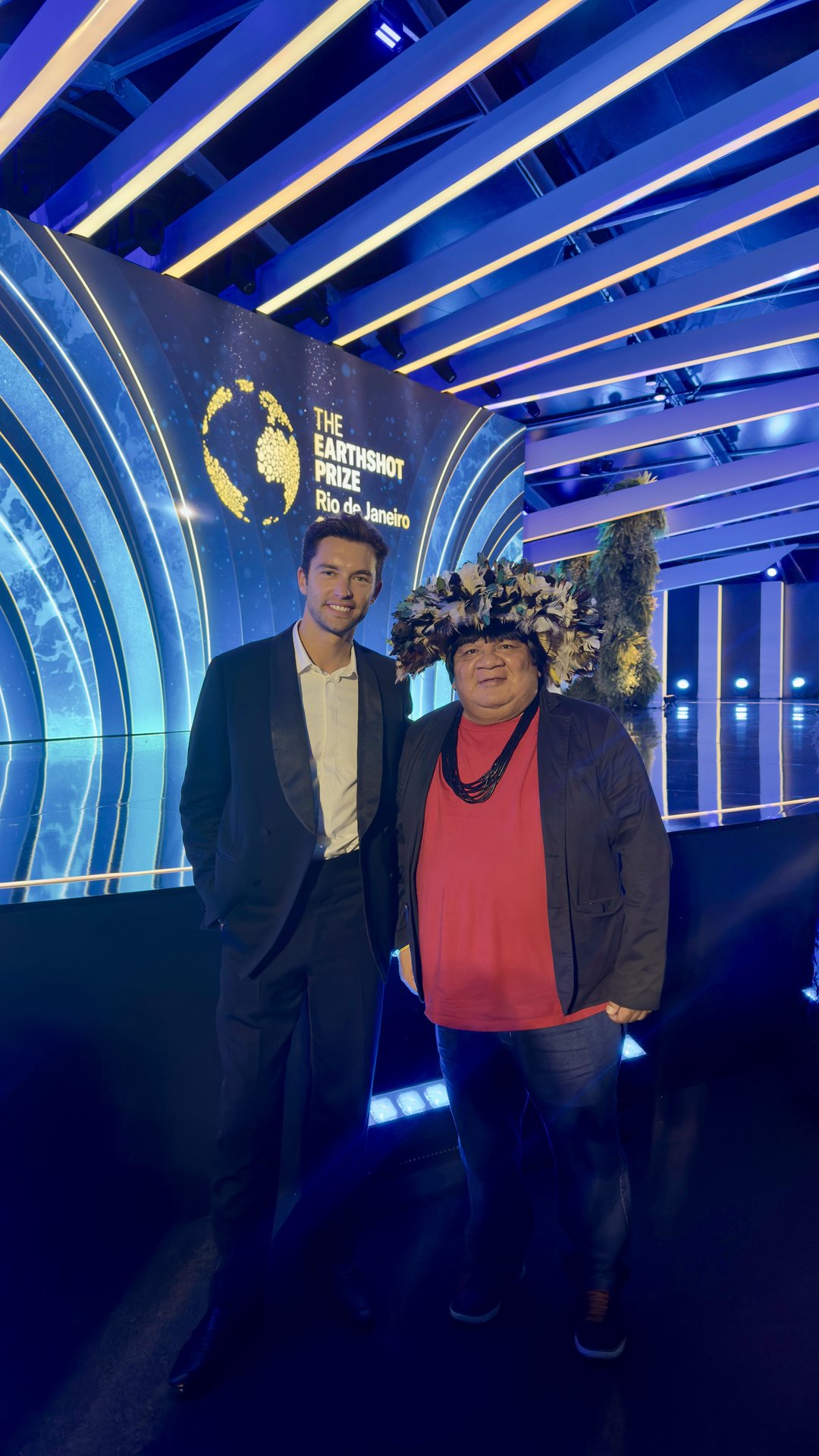 Lucas Garcez with an Indigenous leader on the Earthshot Prize stage