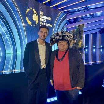 Lucas Garcez with an Indigenous leader on the Earthshot Prize stage
