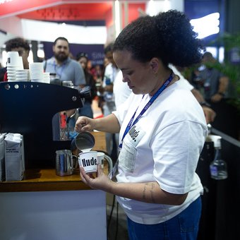 A barista pouring coffee at the Nude stand, Rio Innovation Week